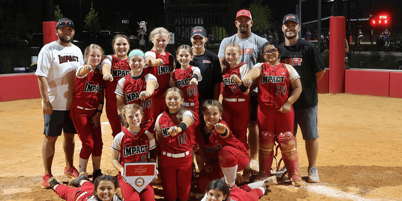 Smiling girls' softball team holding award plaque