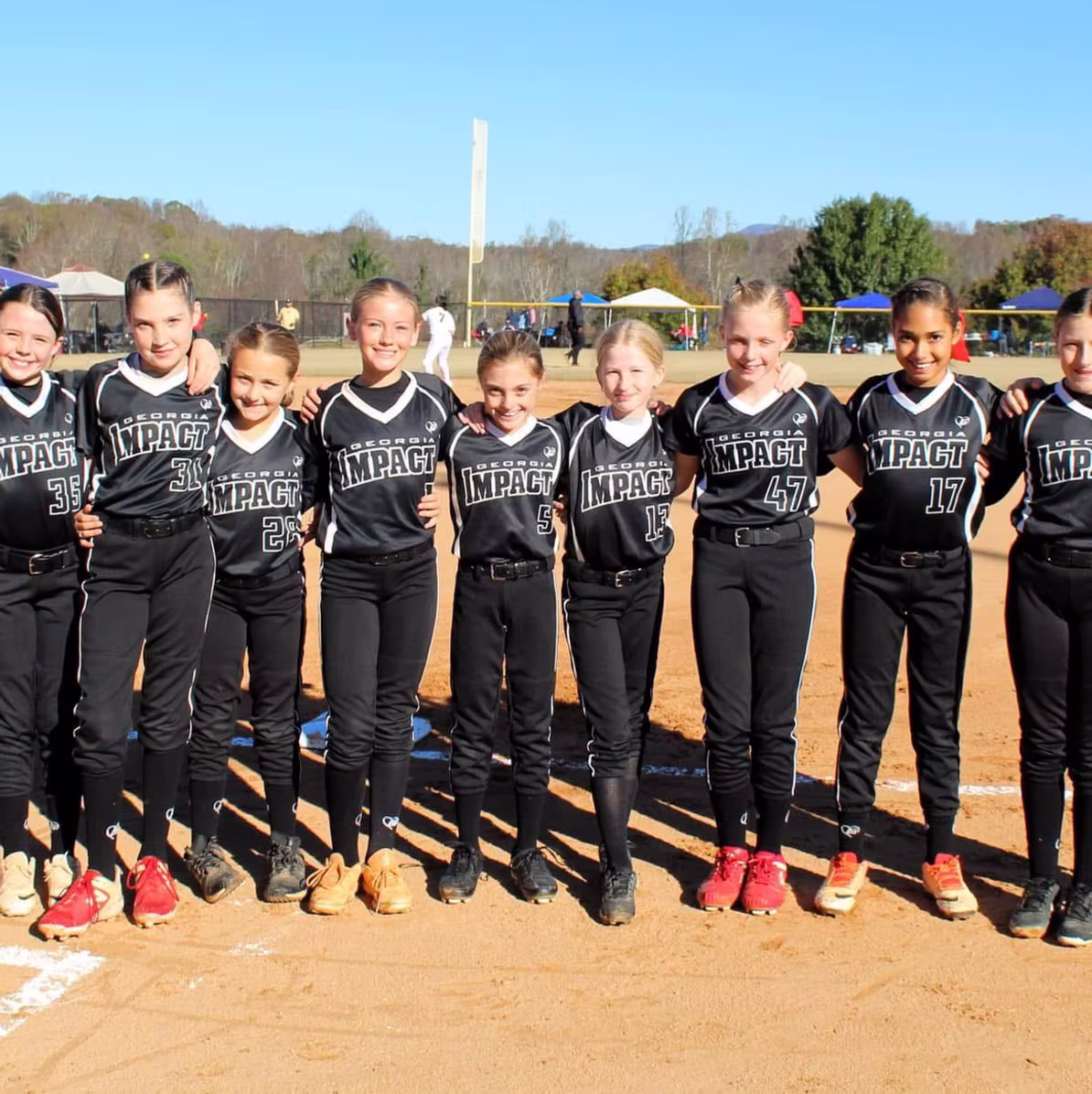 Girls softball team in black uniforms