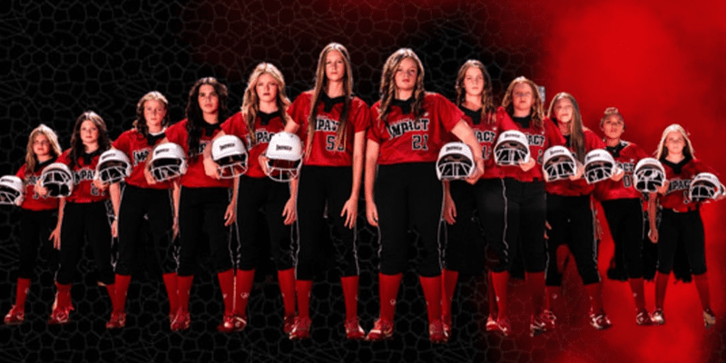 Girls' football team lined up in red uniforms