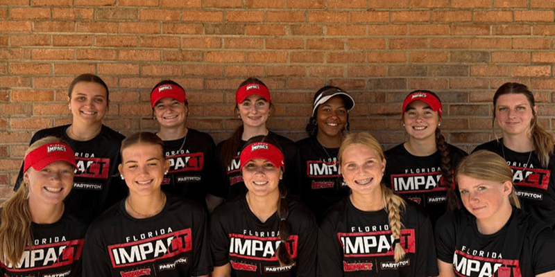 Florida Impact softball team posing against brick