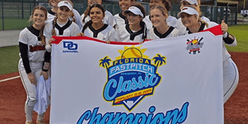 Team holding Florida Fastpitch Classic champions banner