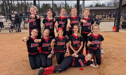 Girls softball team posing on the field.