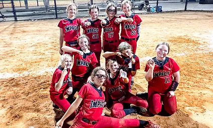 Youth softball team celebrating a victory.