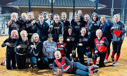 Girls softball team with awards on field