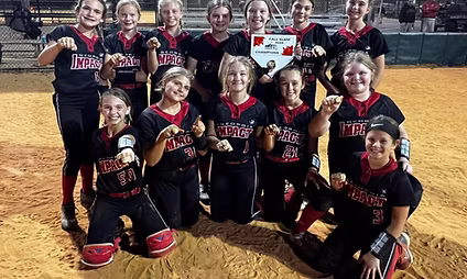 Girls' softball team celebrating with fists raised.