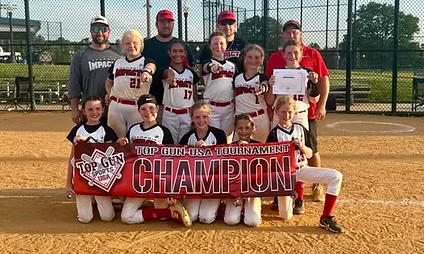 Softball team celebrating tournament championship win.