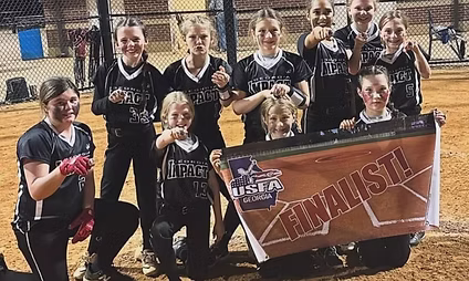 Youth girls softball team with finalist banner