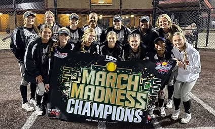 Softball team celebrates March Madness championship victory.
