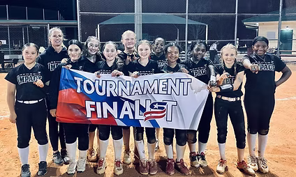 Girls softball team holding "Tournament Finalist" banner.