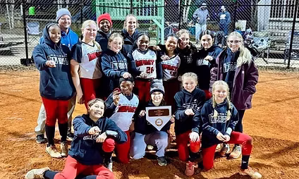 Youth softball team celebrating with tournament plaque