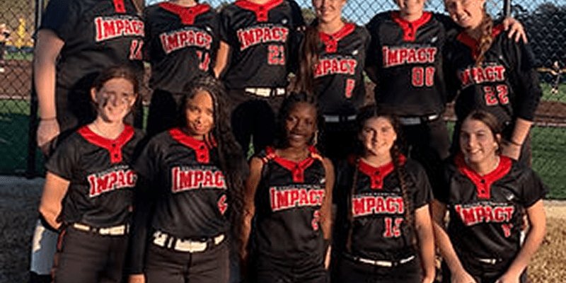 Softball team posing in black and red uniforms.