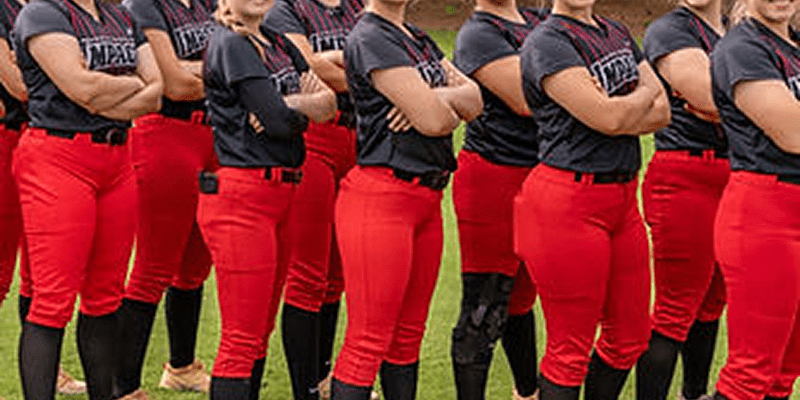 Softball team in red pants, arms crossed