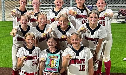 Softball team celebrating with trophy and rings.