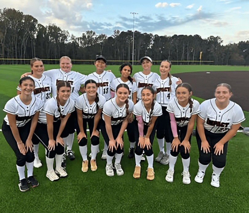 Smiling girls' softball team on field