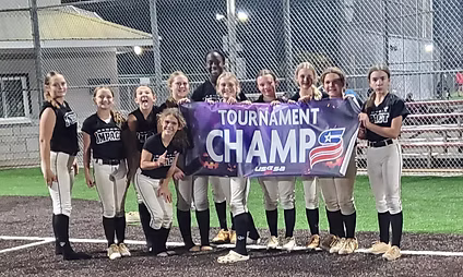 Softball team celebrating with championship banner