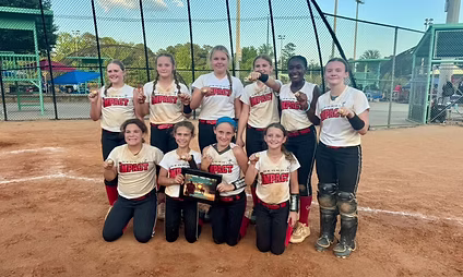 Youth softball team posing with trophy.