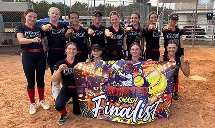Softball team holding "Finalist" banner on field.