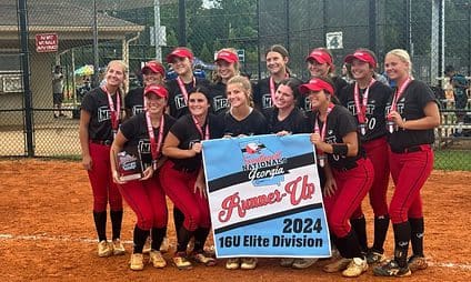 Softball team posing with runner-up banner.