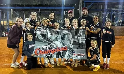 Youth softball team holding 2025 champions banner