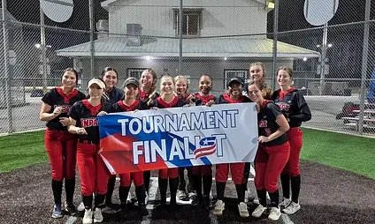 Softball team holding "Tournament Finalist" banner.