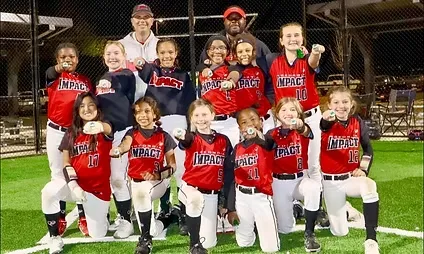 Impact youth softball team posing on field