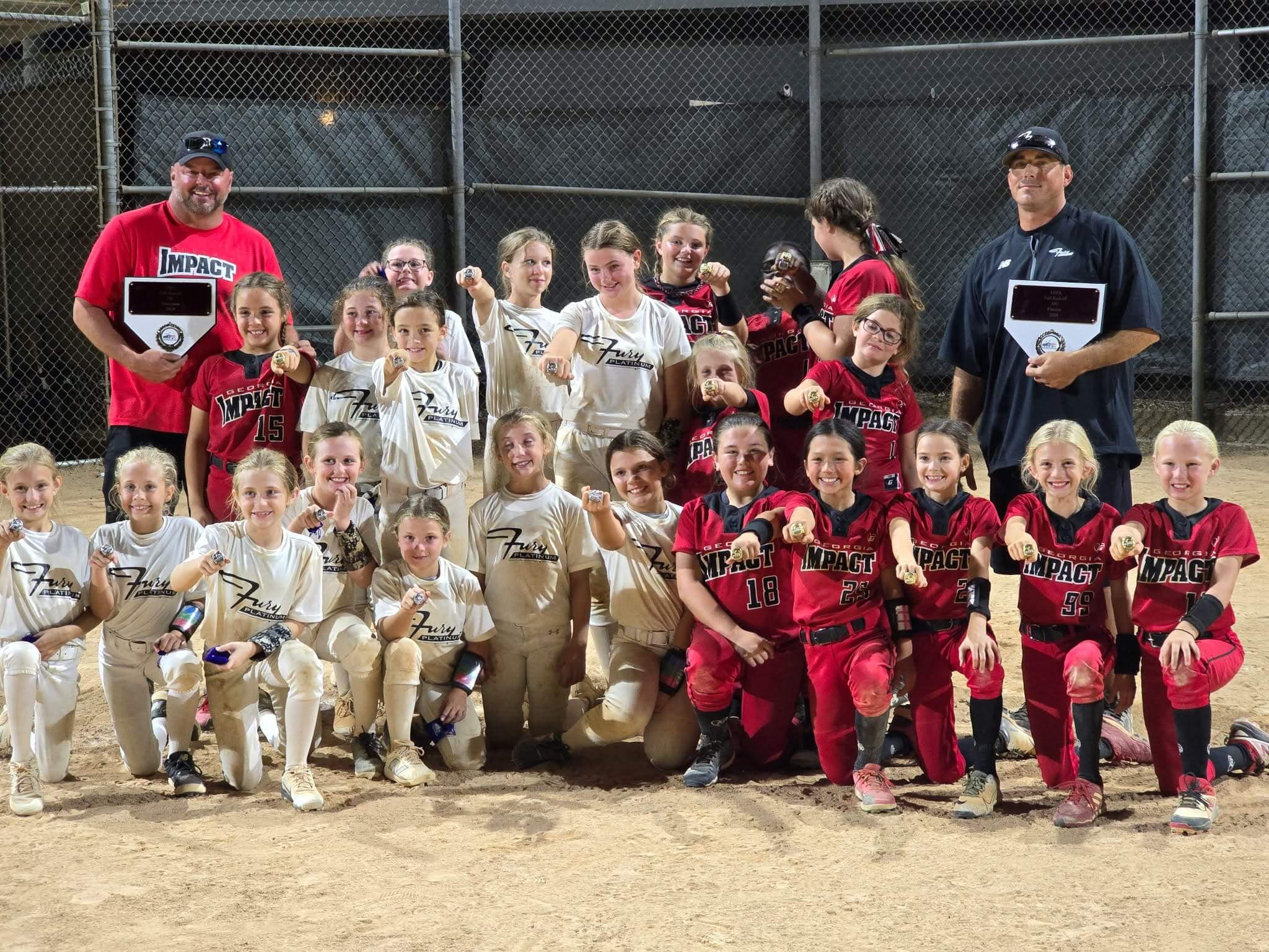 Two youth baseball teams posing together on the field after a game.