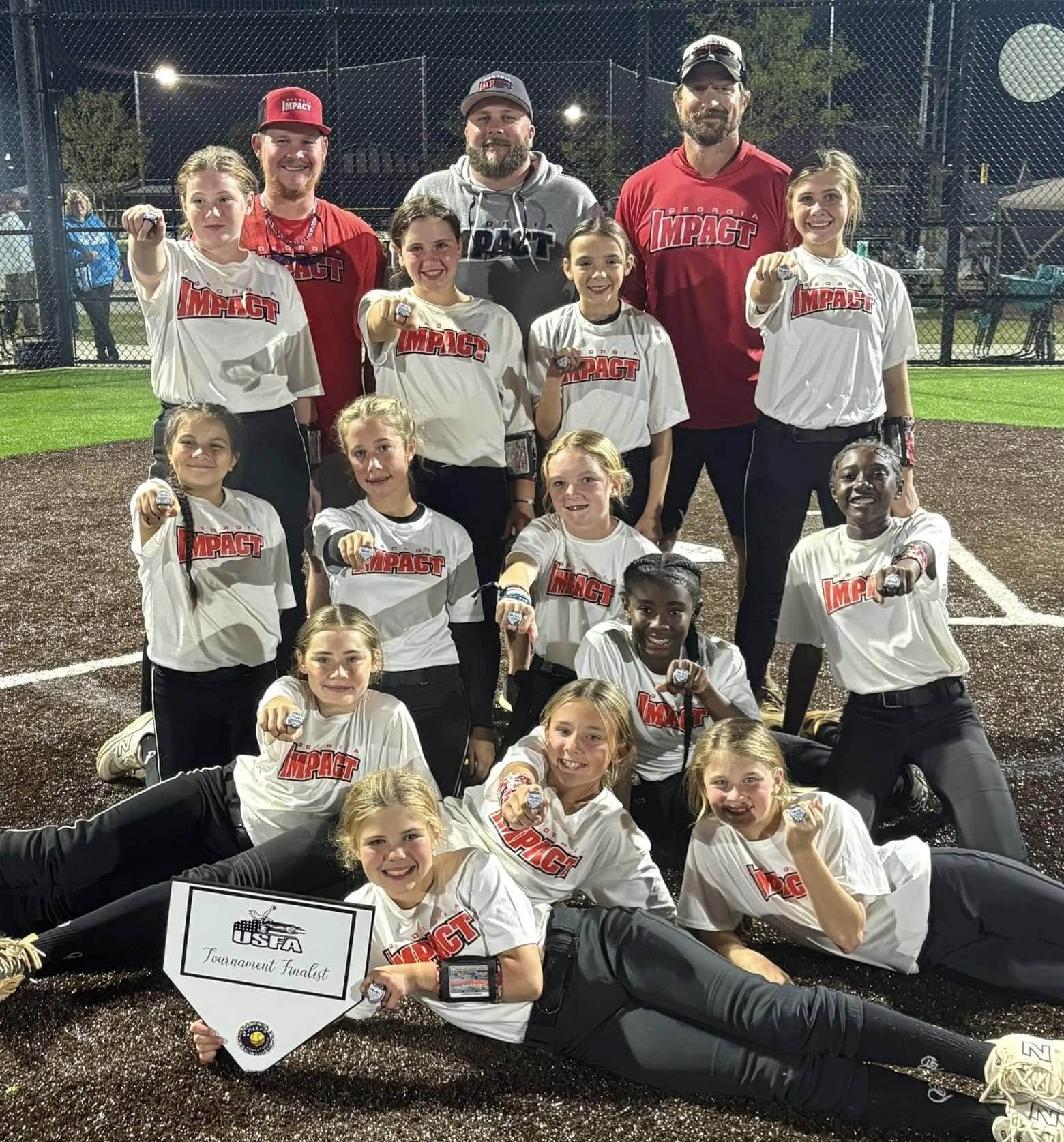 Youth baseball team posing with championship trophies and awards.