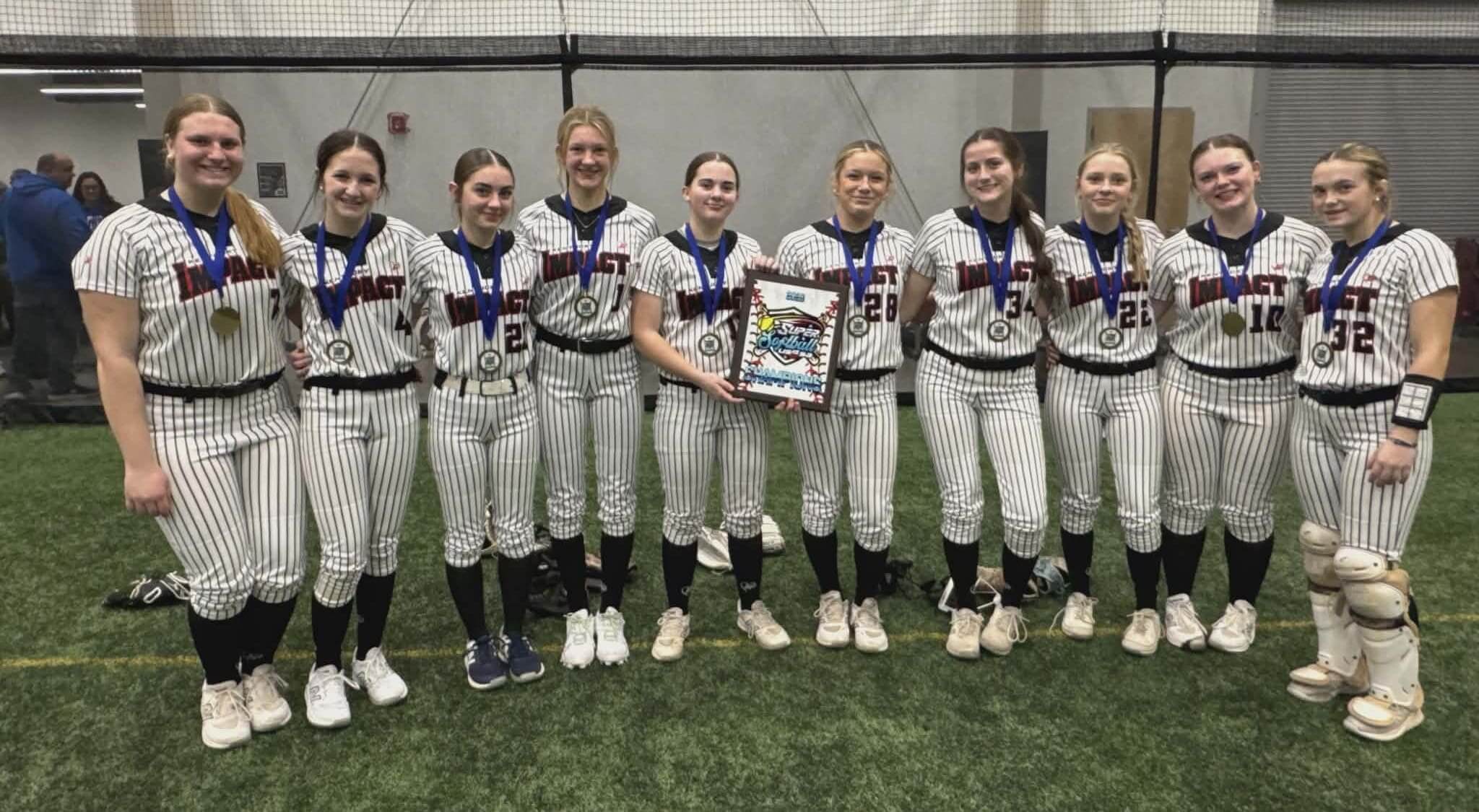 Girls' softball team posing indoors with a plaque.