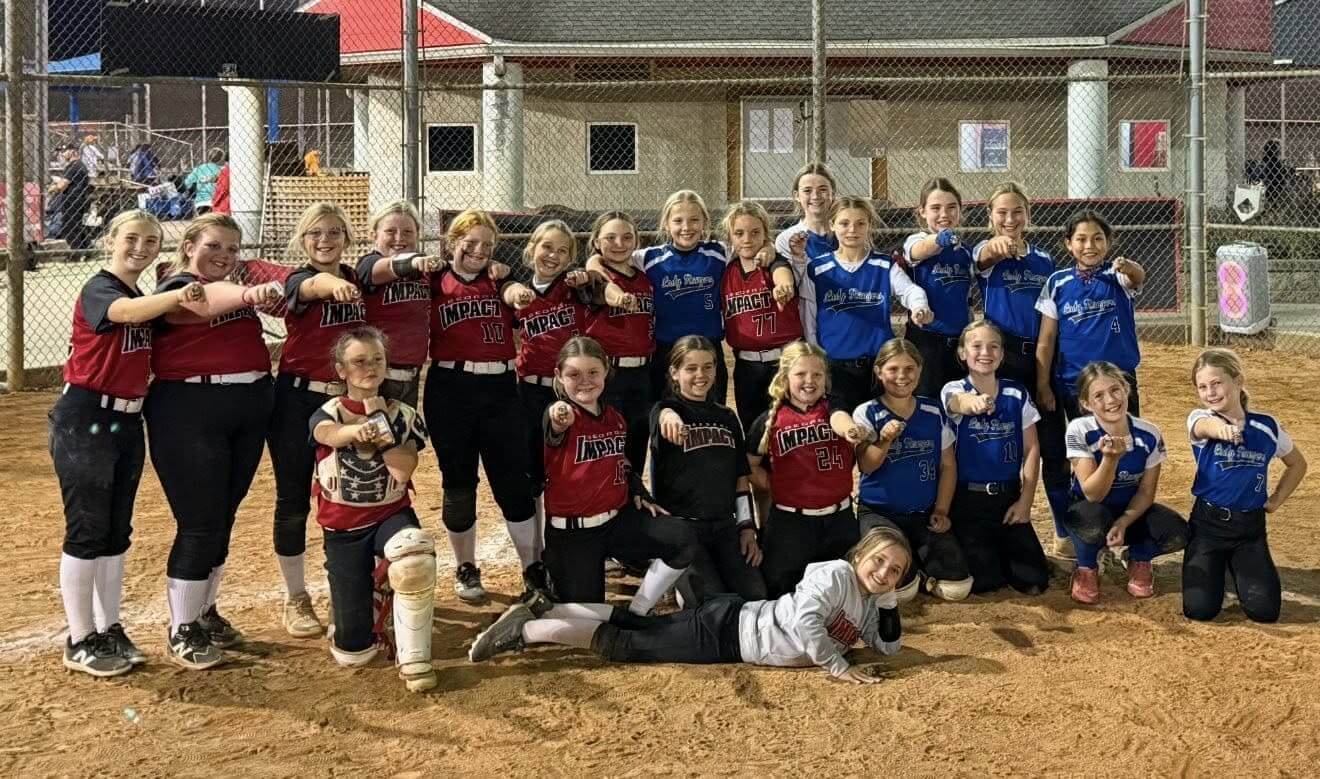 Two youth softball teams posing together