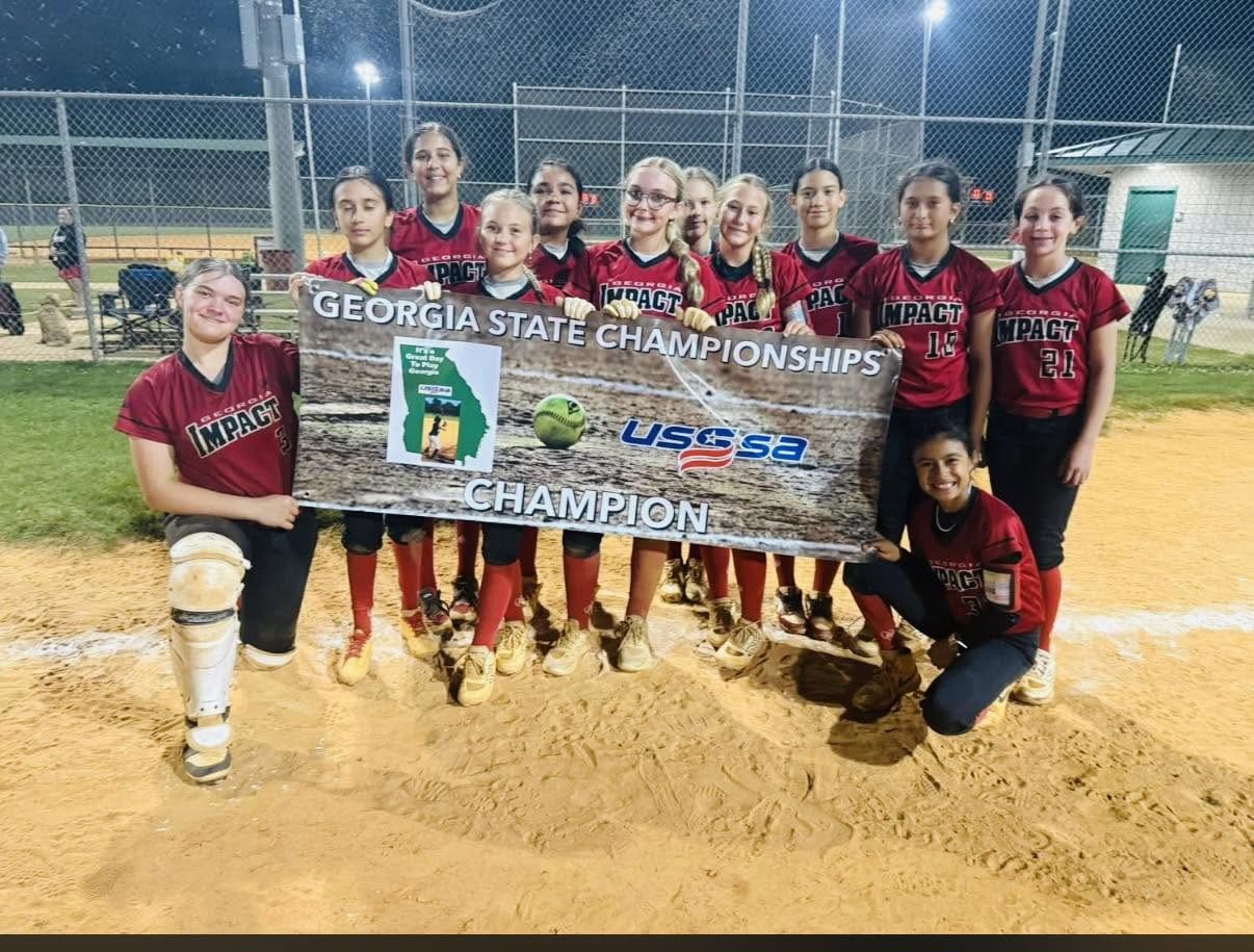 Girls softball team holding Georgia State champion banner