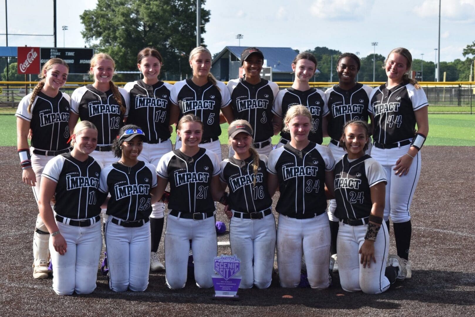 Girls softball team posing with trophy