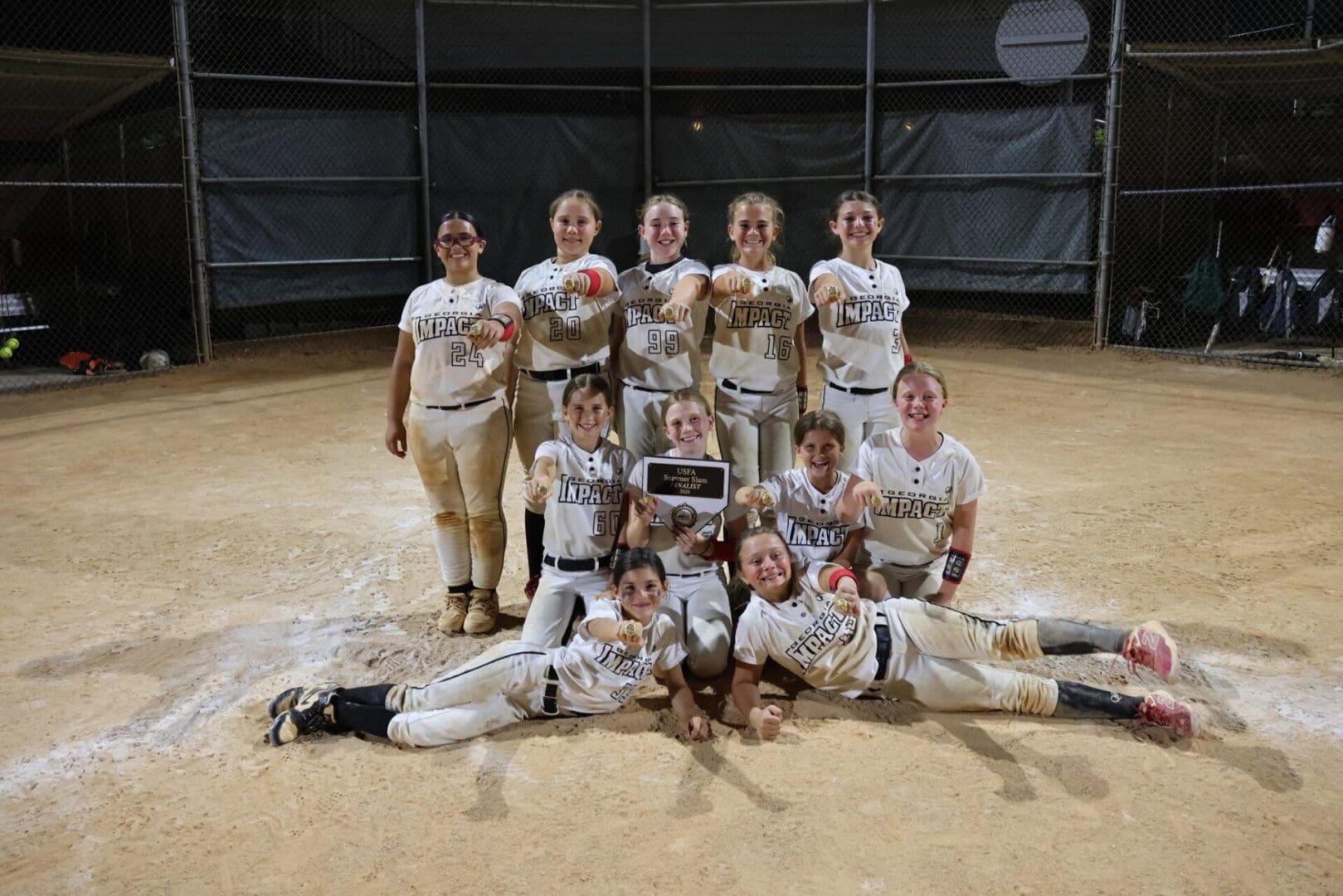 Youth softball team posing with plaque